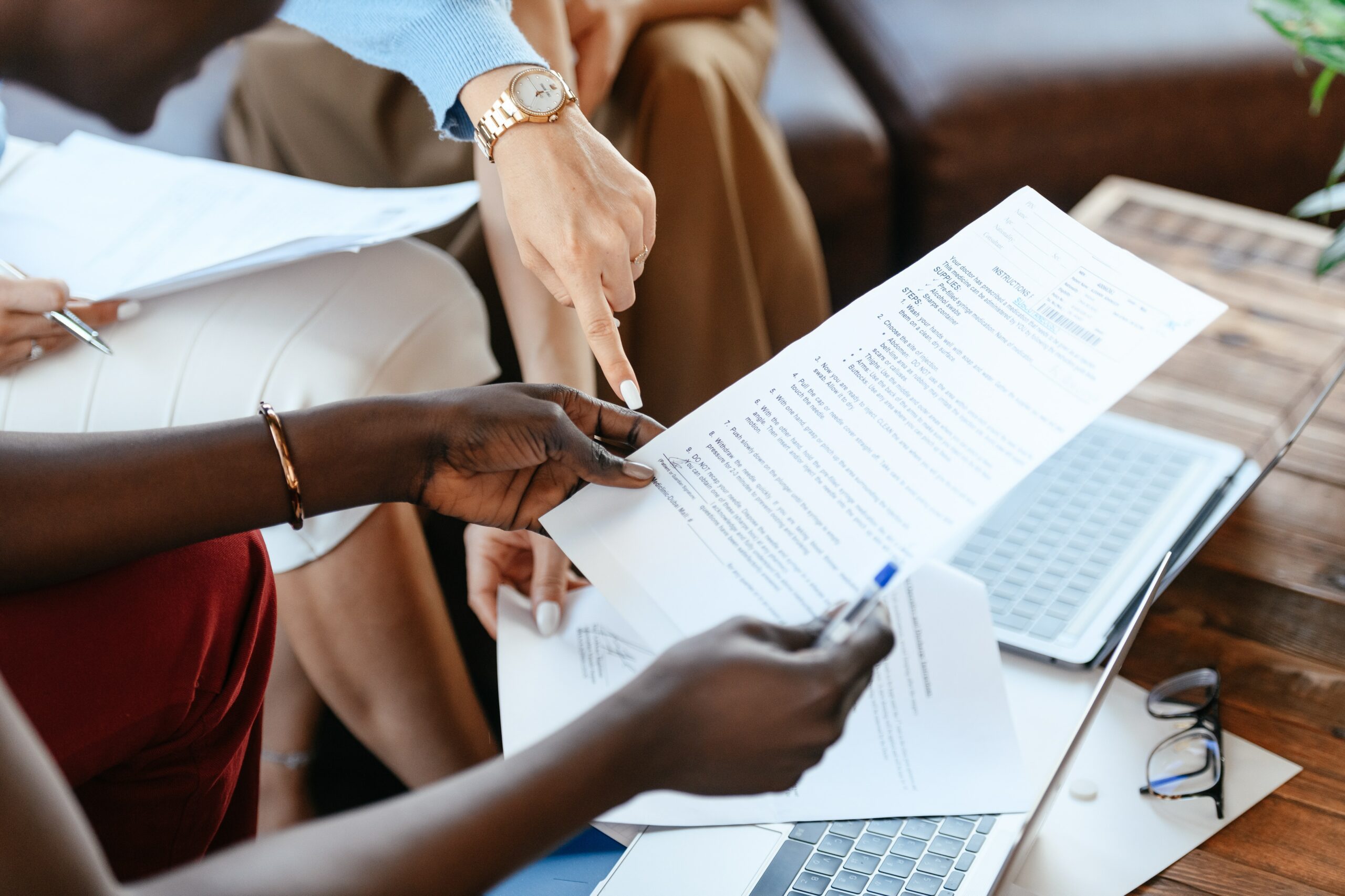 Two consultants reviewing a report together, pointing to a specific line item