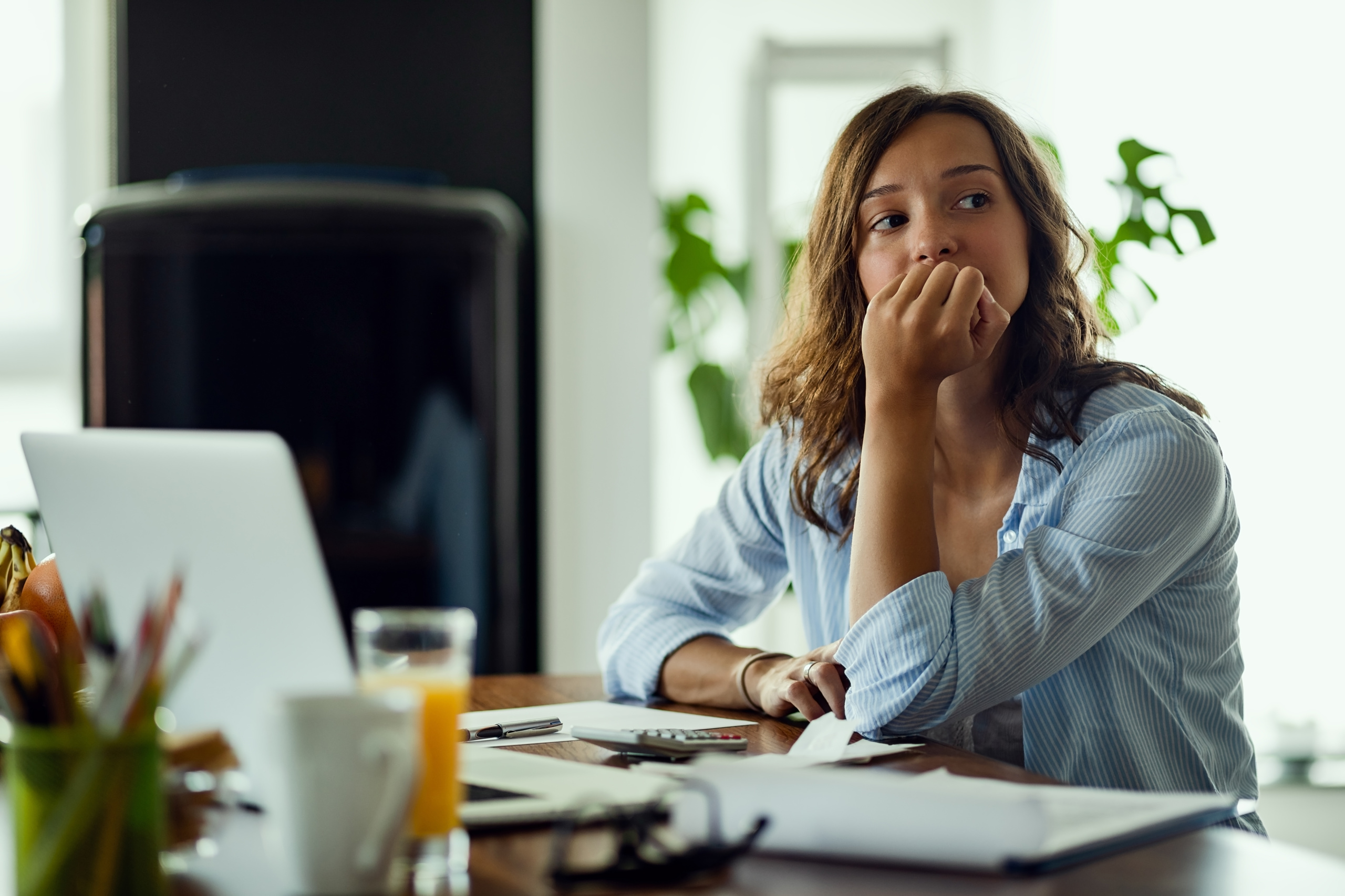 young worried woman thinking something while calculating her home budget 1 scaled