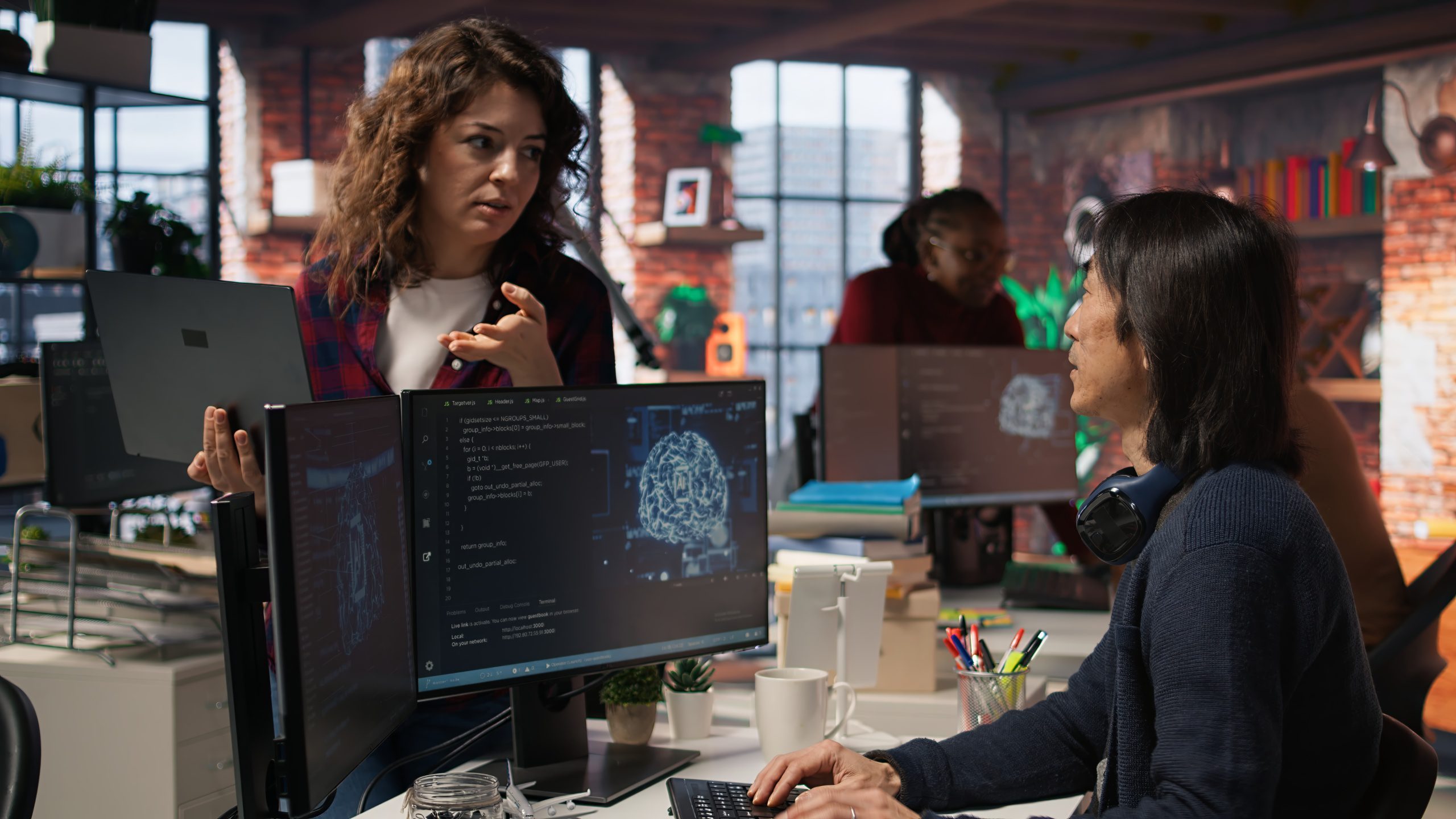 ai startup intern holding laptop asks questions senior technician scaled