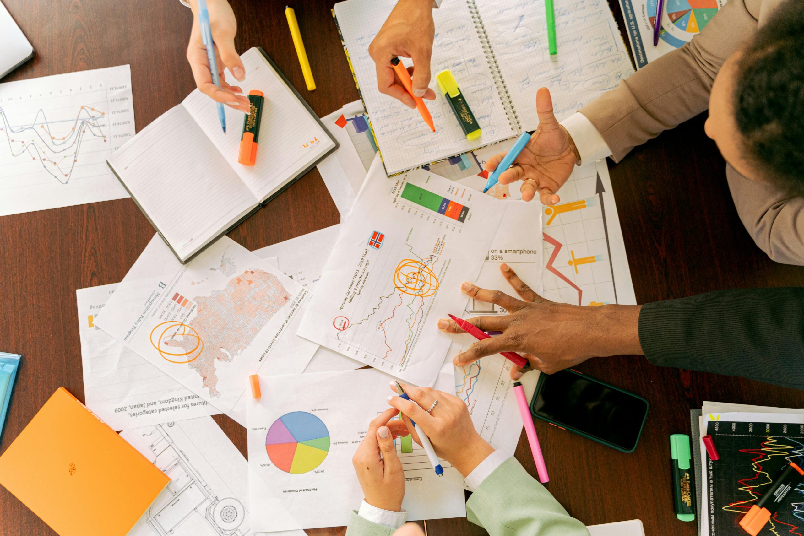 Papers with charts scattered on a desk
